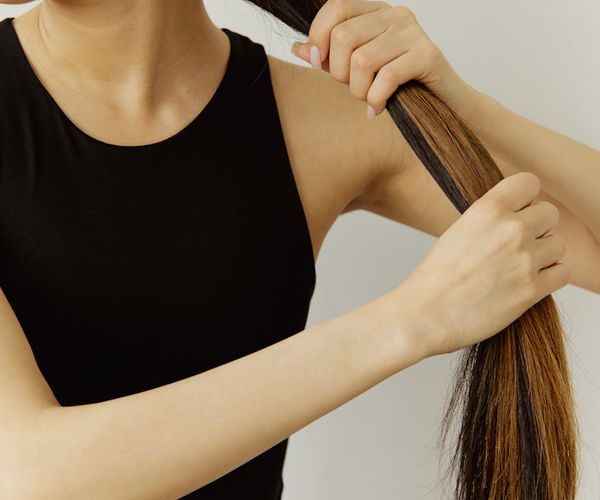 Close-up of a person's hands holding a smooth, simple stone.