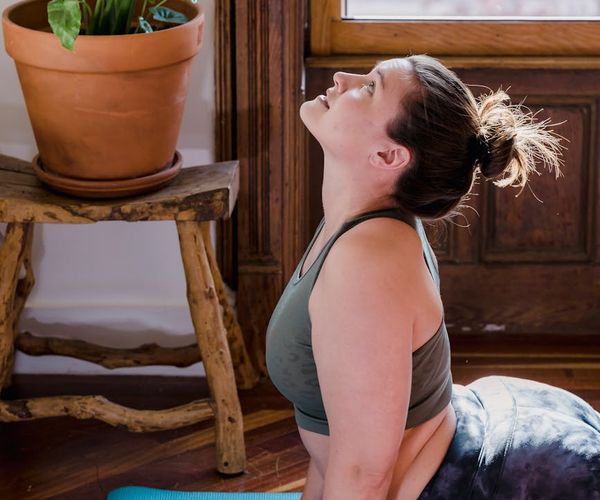 Person doing a simple stretching exercise near a window at home.